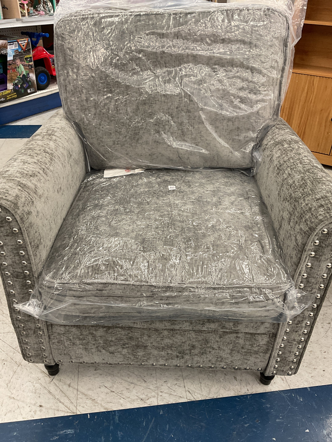 Gray rolled-arm accent chairs with nailhead trim and turned wooden legs
